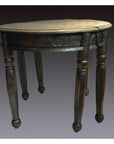 Nickel-silver demi-lune table with repousse detailing against a plain background.