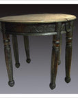 Nickel-silver demi-lune table with repousse detailing against a plain background.