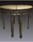 Nickel-silver demi-lune table with repousse design, split in half, set against a dark background.