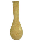 Close-up of a beige clay Roman Lacrimarium with a tall narrow neck and rounded base, weathered surface visible.