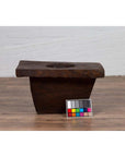 Brown wooden planter on wooden floor with color card in front, antique Indonesian style, early 20th century.