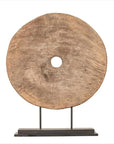 Brown wood ox cart wheel with central hole, 19th century Thailand, displayed on black painted base.