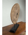 Brown wooden ox cart wheel with black painted base displayed on a wooden table.