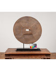 Brown wooden ox cart wheel, 19th-century Thailand, displayed on black painted base.