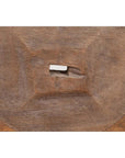 Close-up of a brown wooden ox cart wheel from Thailand on a black painted base.