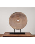 Brown wood ox cart wheel, 19th century Thailand, mounted on black painted base, upright display.