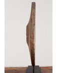 Brown wooden ox cart wheel from Thailand on black base, side view, plain background.