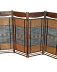 Brown wooden and bamboo folding room divider with woven panels, freestanding in a living space setting.