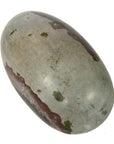 Close-up of large oval Shiva Lingam fertility stone, smooth metallic surface with reddish-brown and gray patches on white.
