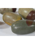 Multicolored oval Shiva Lingam fertility stones, stone material, close-up on white background.