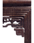 Close-up of dark wood carved and embellished side of antique Chinese side table.