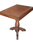 Brown wooden Colonial tripod table with rectangular top and central pedestal, natural patina finish, close-up view.