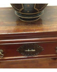 Brown wood console table with horse hoof legs, metal handle drawers, and a decorative dark bowl on top.