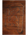 Brown wood signboard close-up with carved Chinese characters, showing intricate grain and texture.
