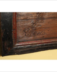 Black metal-framed signboard with Chinese characters on a yellow wall.
