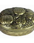Silver plate jewelry box with embossed pumpkins, pears, and berries on oval lid, close-up view.