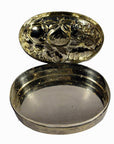 Silver plate jewelry box with ornate fruit designs inside the lid and empty interior, close-up on plain background.