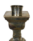 Silver plated brass candle holder with square base and round top in vintage Indian style, on white background.