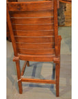 Small wood Arts & Crafts style chair with backrest on light wood floor, rear view.