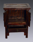 Small elmwood side table with open drawer and two open doors, set against a gray background.