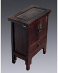 Dark weathered Chinese elmwood side table with brass clasps and hinged lid, close-up view.