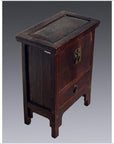 Dark weathered Chinese elmwood side table with brass clasps and hinged lid, close-up view.