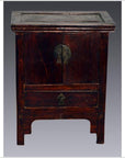Small Chinese elmwood side table with brass hardware, single drawer, and double doors against gray background.
