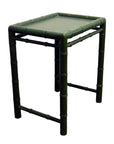 Close-up of small green bamboo side table with square shape and bamboo-style legs and edges.