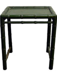 Small green bamboo side table with bamboo-inspired legs, close-up against a plain background.