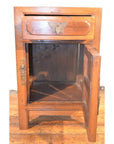 Light wood side cabinet with butterfly brass hardware on a wooden floor indoors.