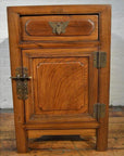 Wooden side cabinet with butterfly brass hardware, metal latch, and panel detailing in Chinese-inspired style.