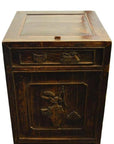 Dark wood carved side cabinet with hand-carved details and brass medallion on front panel and drawer, studio view.