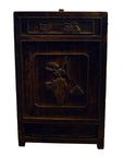 Dark wood carved side cabinet with ornate designs and a musician figure on the front panel, studio setting.