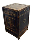 Dark wood antique side cabinet with metal handles, hand-carved details, and visible age and wear on the surface.