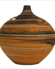 Close-up of orange and black ceramic vase with narrow neck and artisan striped patterns.
