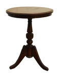Brown wooden round table with pedestal base and three curved legs, suitable for small or corner spaces.