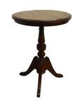 Close-up of a round wooden pedestal table with three curved legs on a plain white background.