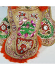 Close-up of Taiwan Opera Doll with gold fabric, colorful embroidery, sequins, and vibrant orange fur trim.