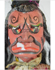 Close-up of a Taiwan Opera Doll with vibrant painted mask, dramatic colorful facial features, porcelain material.