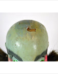 Close-up of a painted ceramic Taiwan Opera Doll head with cracked paint and visible damage on the top.