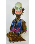 Close-up of Taiwan Opera Doll with fierce face, wild hair, and blue-gold costume decorated with pink heart details.