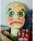 Close-up of a colorful Taiwan Opera Doll with vibrant makeup and exaggerated facial features, ceramic material.