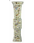White porcelain vase with hand painted vibrant florals and delicate butterflies, faceted shape, shown against a plain background.