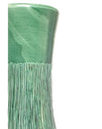 Close-up of green ceramic tall vase with glossy finish and vertical textured lines on a plain white background.