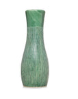Green glossy ceramic vase with textured vertical lines and flared top, close-up on white background.