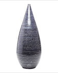 Black and white ceramic Thai vase with horizontal stripes, teardrop-shaped and narrow at the top, close-up view.
