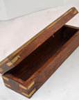 Brown teakwood pencil and jewelry box with open hinged lid on a white surface.