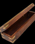Brown teakwood pencil and jewelry box with brass accents, open on a black background.