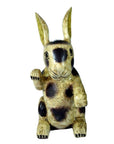 Close-up of vintage hand painted ceramic Thai Begging Rabbit figurine with tall ears, raised paw, and worn finish.