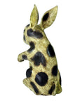 White ceramic Thai Begging Rabbit figurine with upright ears, hand painted, rear view on white background.